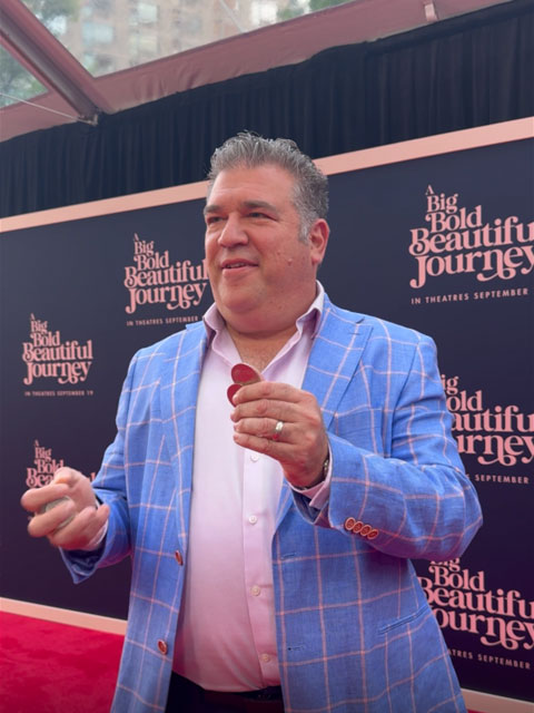 Scott performing coin magic at a NYC movie premiere.